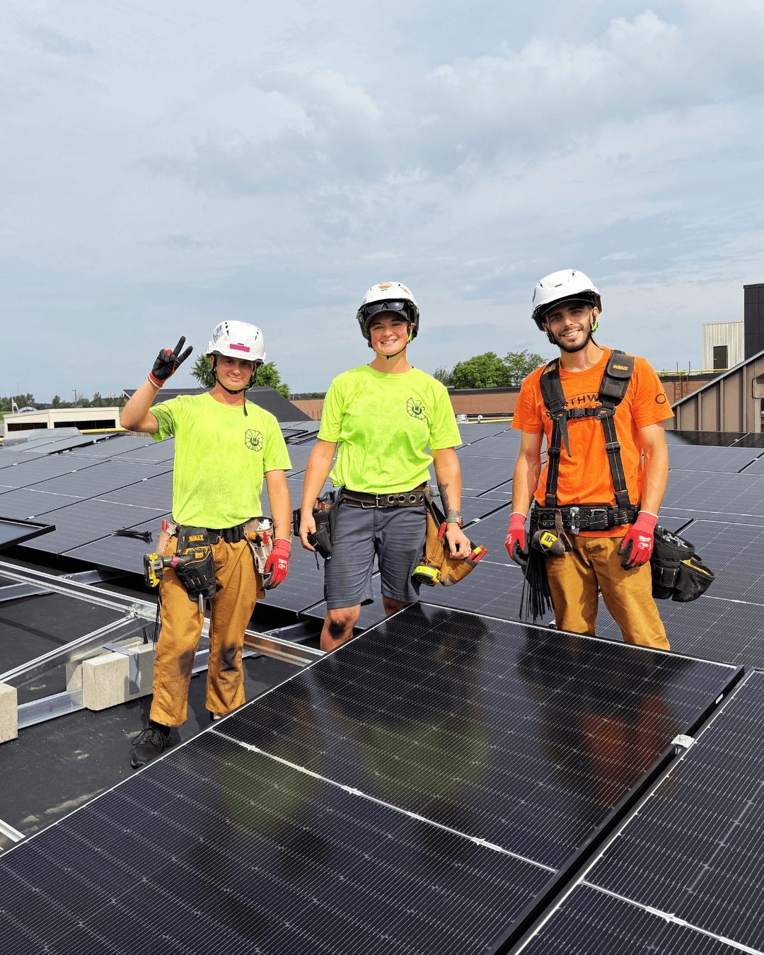 Northwind Solar installers standing on a rooftop solar array Northwind Solar installers standing on a rooftop solar array